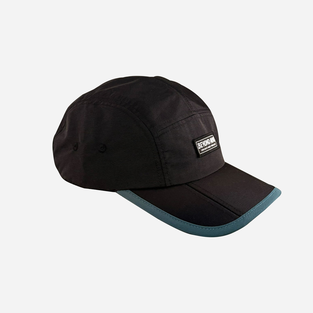 Beyond Arno foldable trail cap with zipped pocket in teal, side 2 view